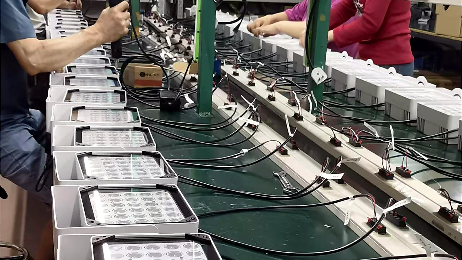 Workers assembling and testing Accurates LED lighting products